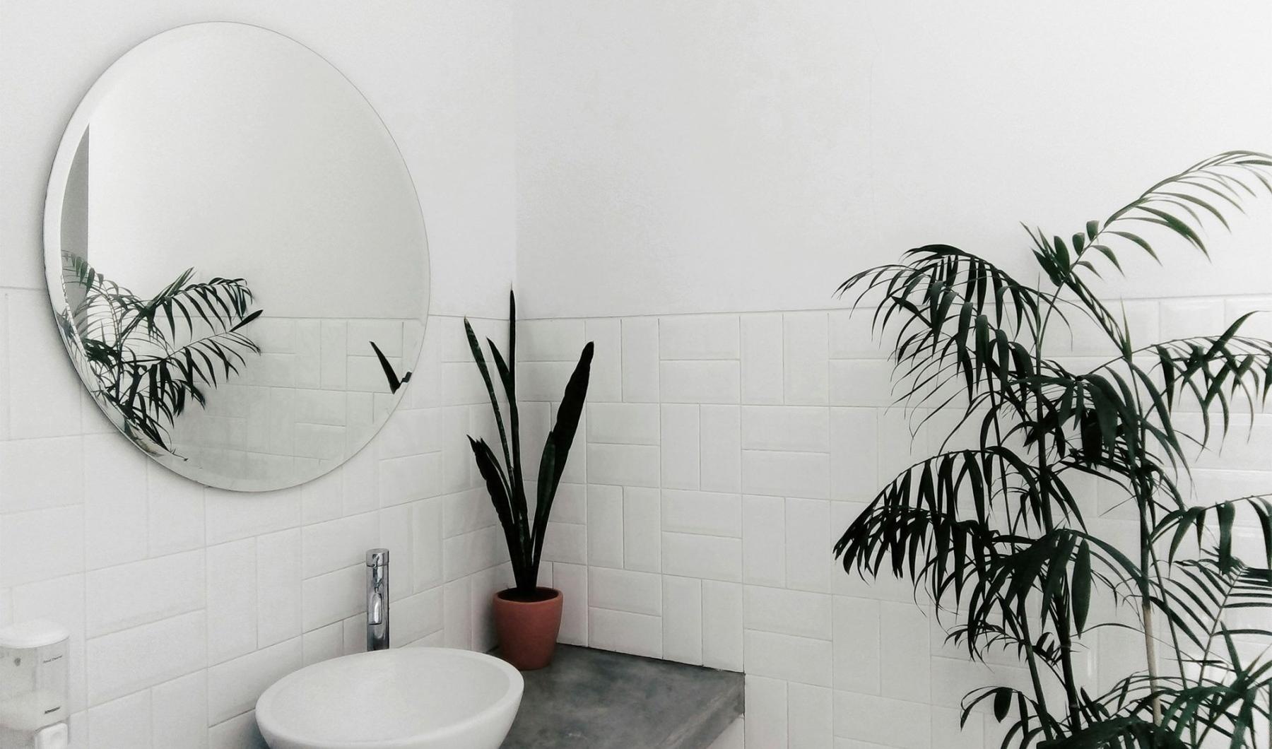 a bathroom with a round mirror