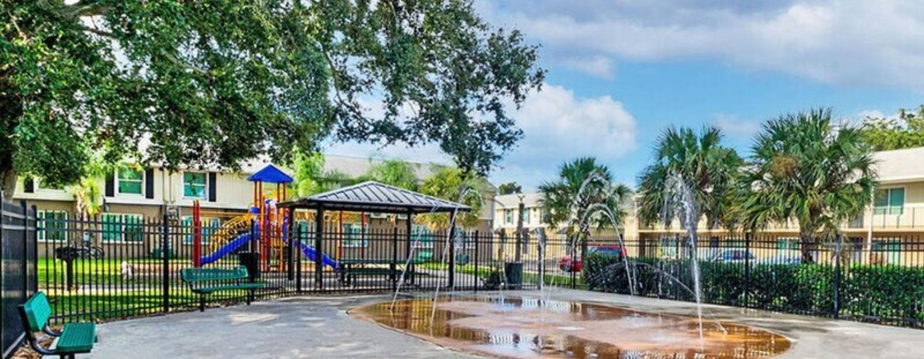 a pool with trees and buildings around it